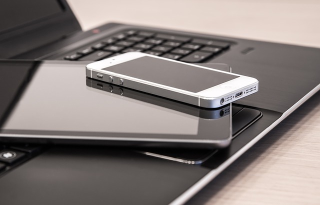 laptop with a phone on top
